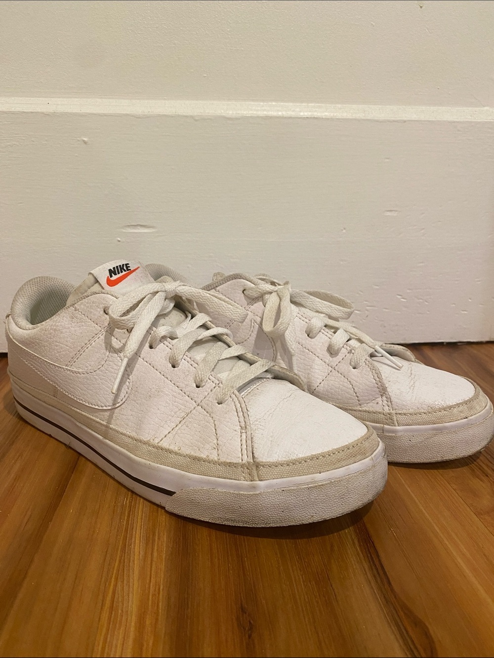 Nike Women's White Low-Top Sneakers with Orange Logo Accent